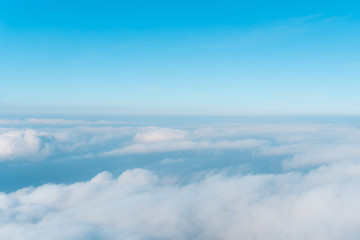 Wall Mural - airplane window view above beautiful white cloud summer blue sky and sun light abstract nature.