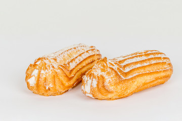 Two custard cakes shot on a white background under tenderloin