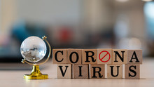 Concept Coronavirus. Prevent Or Stop The Spread Of The Corona Virus Worldwide. Letters On The Wooden Floor Resting On A Wooden Table. Tourists Stop Travel To Travel From China. And Related Country.