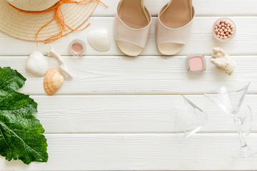 Wall Mural - Female outfit. Clothes, shoes, cosmetics on white wooden background top-down frame copy space