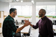 © JonoErasmus - Two diverse businessmen friends about shake hands smiling and greeting. Happy to meet