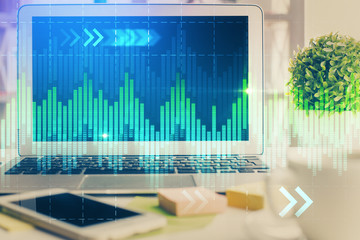 Financial graph colorful drawing and table with computer on background. Multi exposure. Concept of international markets.