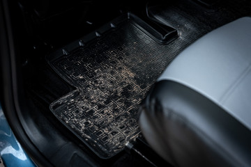 Dirty rubber carpet in car.