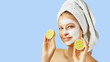 © Olesia - Cosmetology, skin care, face treatment, spa and natural beauty concept. Woman with facial mask holds lemons.