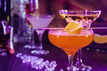 Two beautiful cocktails served on a wooden bar counter