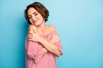 Sticker - Photo of pretty lady dreamer hug herself enjoy own company eyes closed peaceful good mood wear casual white red open naked shoulders blouse isolated blue color background