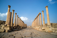 A View Looking Down The Cardo Showing Stone Carved Columns And Paved Street At The Ancient City Of Jarash Or Gerasa, Jerash In Jordan. Ancient Roman Sights.