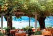 Beautiful scenic view on cozy restaurant in Bellagio on Lake Como, lombardy, North Italy with water of Como, small boat and Alps mountains on background. Famous tourist destination. Travel