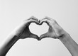 © Kanstantsinzzz - Female hands that make a heart shape. Heart shape with female hands. Close-up. Sign of love.  Black and white image