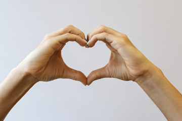 Female hands that make a heart shape. Heart shape with female hands. Close-up. Sign of love.