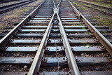 Fototapeta  - Large empty railroad crossing without fork. Concept of industrial logistic and transportation background with selected focus on intersection with copy space