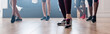 © LIGHTFIELD STUDIOS - Cropped view of multicultural dancers training zumba in dance studio, panoramic shot