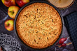 Whole traditional European apple pie with topping crumbles in springform pan