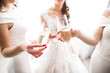 © olegparylyak - Photo bride with her friends drinking champagne from glasses