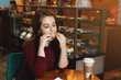 © Kseniia - cute girl having lunch sandwich and coffee in cafe