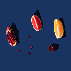 flat lay layout with summer citrus fruit on blue background. minimal concept with sharp shadows. tre