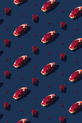 Poster - Flat lay pattern with summer pomegranate fruit on blue background. Minimal concept with sharp shadows. Trendy social mockup or wallpaper.