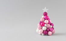 Christmas Tree With Pink Bauble Decoration. Minimal Holiday Composition. Creative Christmas Background.