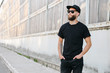 © 4Max - Hipster handsome male model with beard wearing black blank t-shirt with space for your logo or design in casual urban style