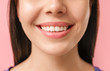 © Pixel-Shot - Young woman with healthy teeth on color background, closeup