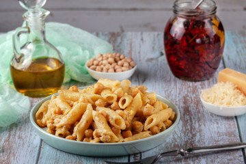 Wall Mural - Italian pasta with chickpeas, spices and tomatoes - closeup