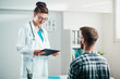 © Suteren Studio - Woman Doctor reads results to Young Patient