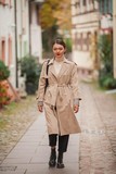 Fototapeta Konie - A beautiful young Asian woman walks in a European city. Fashionable portrait of a young asian woman. Blogger.