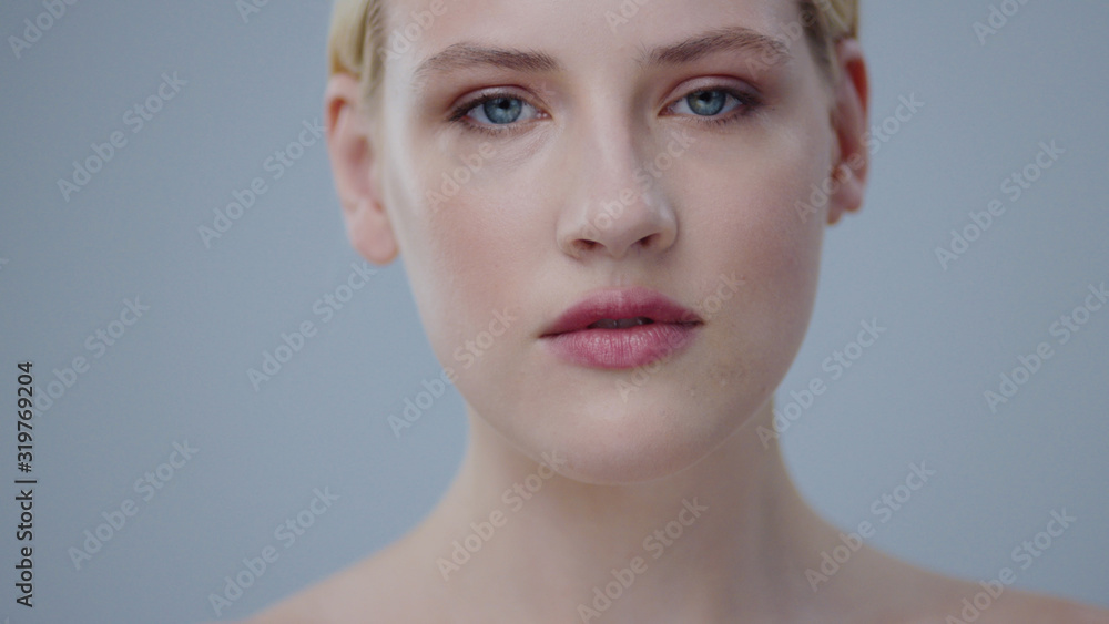 Close-up beauty portrait of attractive nude blonde girl with clear