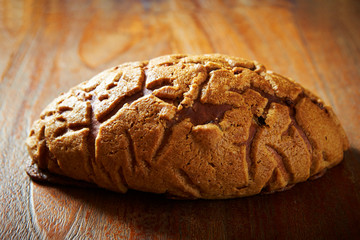 Sticker - Sweet black sugar bread on wooden background 