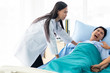 © Toefotostock - Two doctors holding a psycho patient on bed in hospital