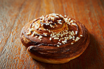 Sticker - Sweet bread roll on wooden background 