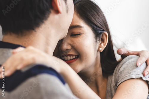 Lovely attractive young Asian couple man kiss forehead of happy woman with and hug in romantic moment Tableau sur Toile