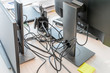 © Konstantin - Clutter in office on the table. Unwound and tangled electrical computer wires. 5S system of lean manufacturing