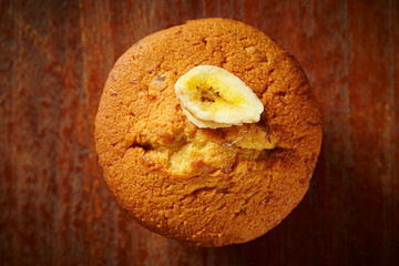 Sticker - Banana cupcake on wooden background 