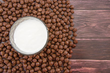 Chocolate Balls And A Glass Of Milk. Dry Breakfast On A Wooden Background. Close-up.