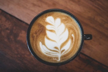 Wall Mural - Close up coffee cup on wooden table 