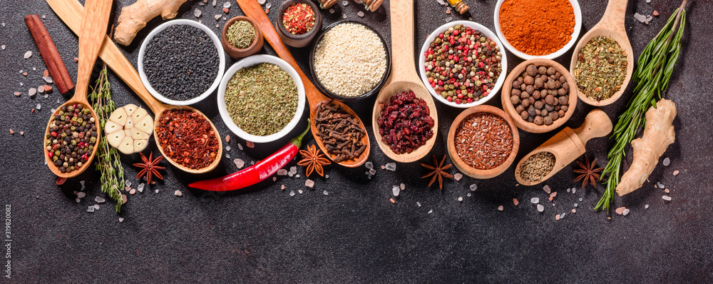 Spices and herbs over black stone background. Top view with free space for menu or recipes - obrazy, fototapety, plakaty 