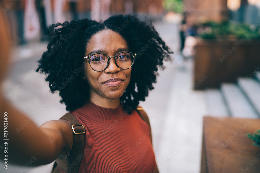 Young black woman smiling and taking selfie Stock Photo | Adobe Stock