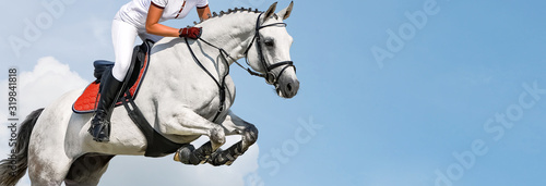 Fotografía Girl jumping with white horse, isolated, blue sky, white clouds background