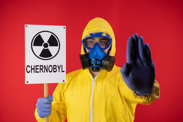 Wall Mural - man, protective, chemical, mask, yellow, suit, banner, hand, inscription, chernobyl, save, planet, sign stop, ecology, concept, protective mask, chemical mask, protective suit, yellow suit, save the p