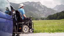 Disabled Man On Wheelchair Using Accessible Vehicle With Lift Or Ramp In Nature