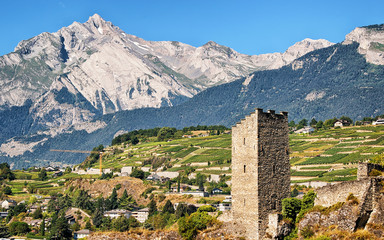 Canvas Print - Majorie Castle and landscape with Haut de Cry mountains in Sion, Canton Valais, Switzerland.