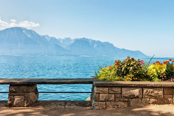 Wall Mural - Bench and flowers blooming at the embankment of Geneva Lake in Montreux, Vaud canton, Switzerland