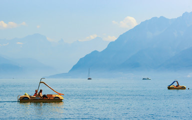 Wall Mural - Lausanne, Switzerland - August 26, 2016: People in catamarans at Geneva Lake in Lausanne, Switzerland