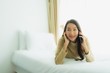 © siraphol - Young asian woman using mobile smart phone on bed