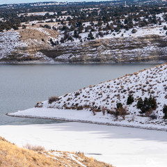 Canvas Print - Square frame Frozen lake and snow covered hills in a dreamy winter wonderland landscape