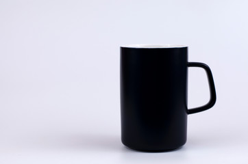 Black ceramic mug on a white background.