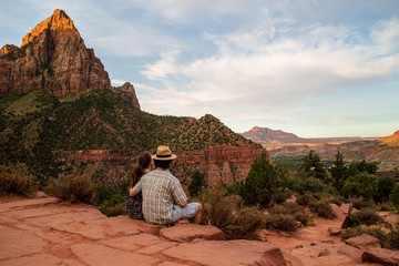 Hiking people - lovely hiker couple on hike outdoors enjoying view from Canyon Overlook trail in Zion National Park, Utah