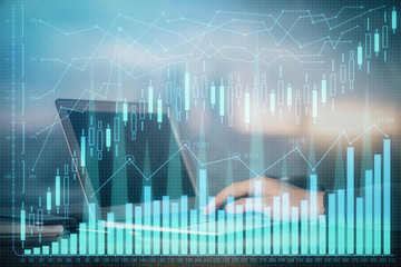 Double exposure of stock market graph with man working on laptop on background. Concept of financial analysis.