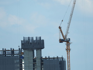 Close up details of a crane's control room, Construction crane tower with blue sky, Under construction site of a new building.